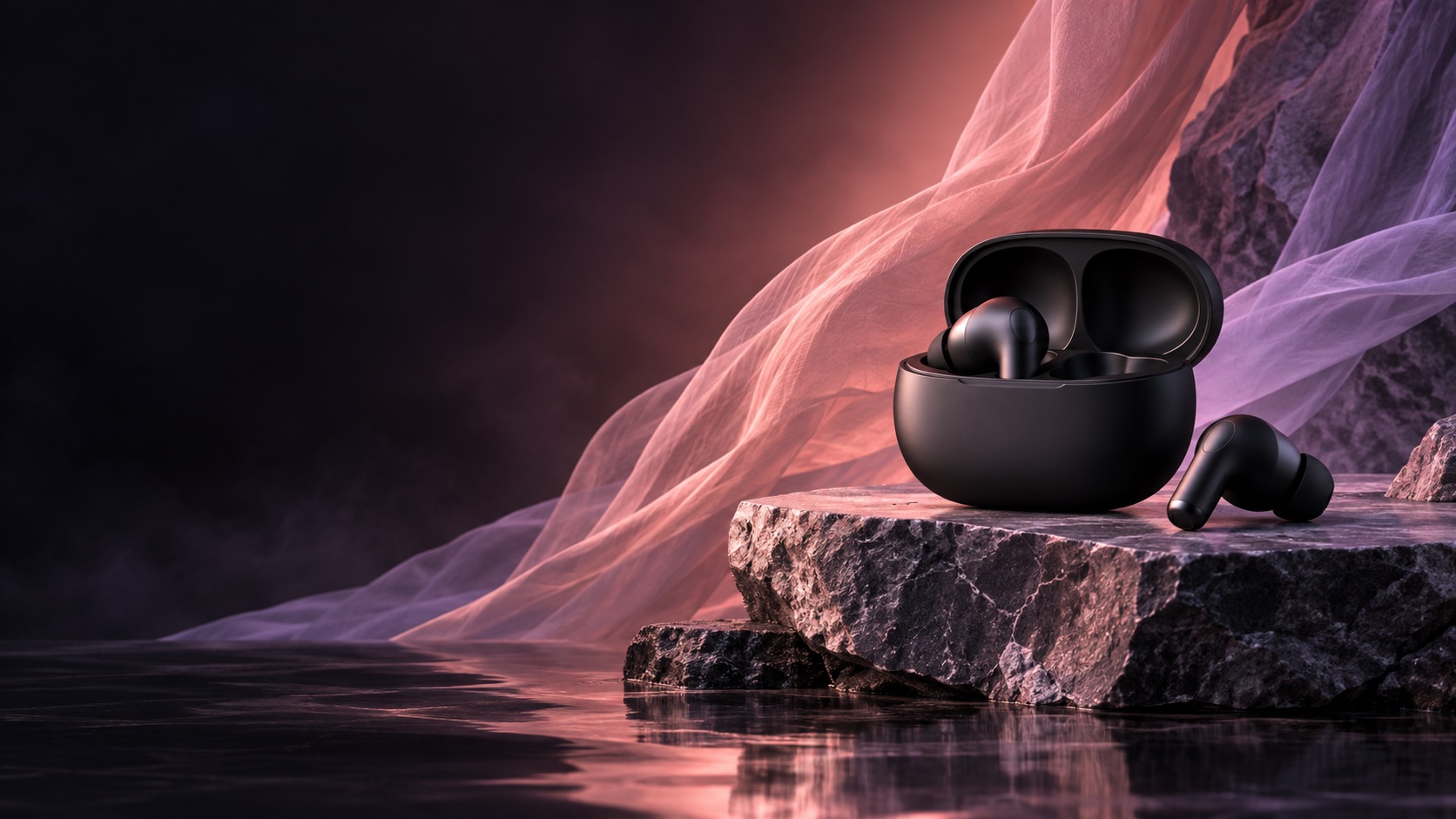 Wireless earbuds arranged on a dark stone surface with pink fabric in the background